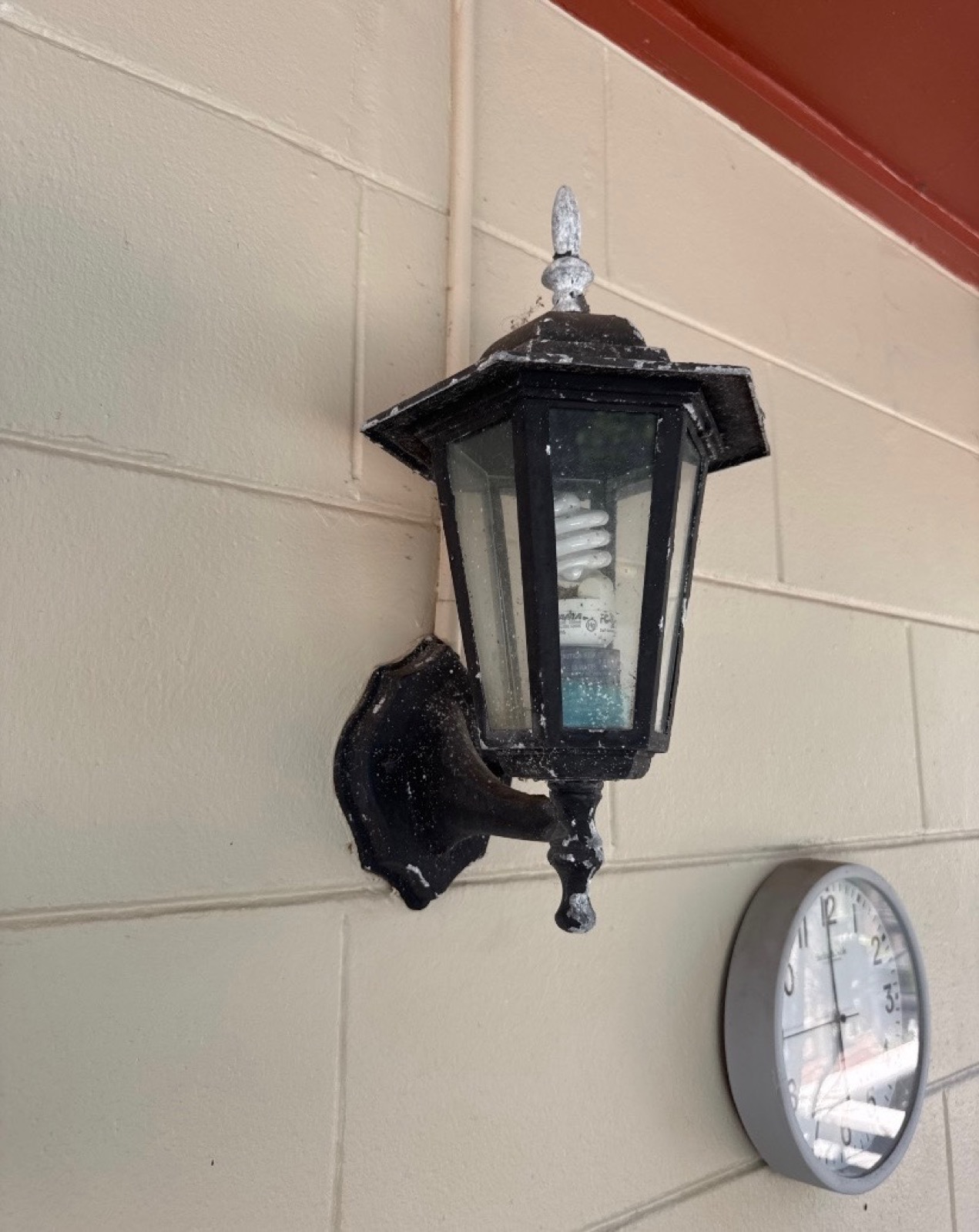 Before outdoor light fixture refurbishment by Flourish Home Services in Tampa Bay