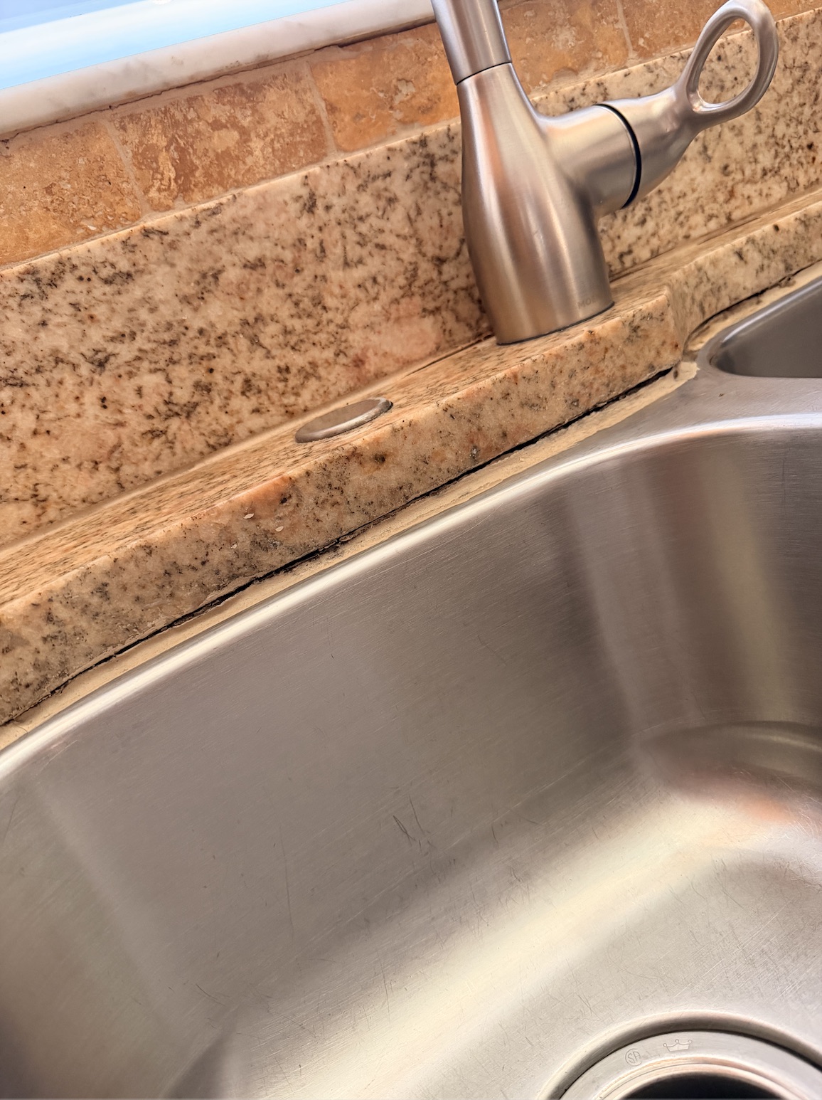 Before worn kitchen sink caulk repair by Flourish Home Services